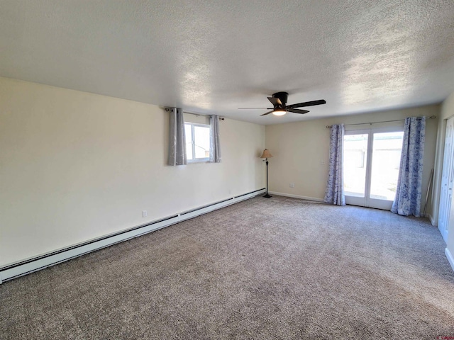 spare room with carpet floors, a textured ceiling, ceiling fan, and a baseboard heating unit