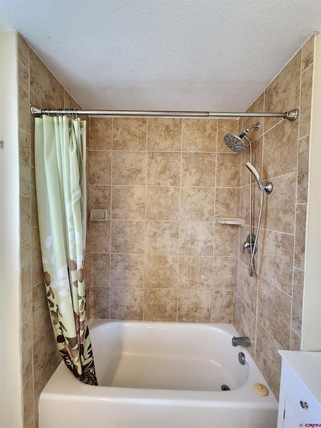 bathroom featuring shower / tub combo with curtain and a textured ceiling