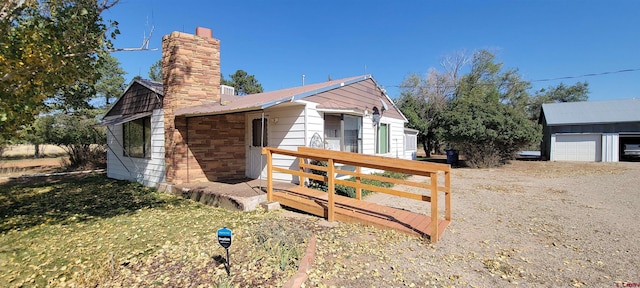 exterior space featuring a garage and an outdoor structure