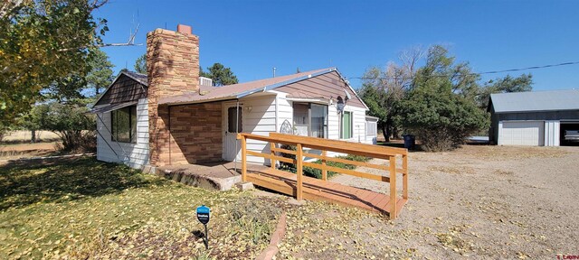 9966 Rd 7, Dove Creek, CO 81324 - view of side of home featuring a chimney and a detached garage