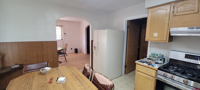 9966 Rd 7, Dove Creek, CO 81324 - kitchen with white fridge with ice dispenser, stainless steel range with gas cooktop, under cabinet range hood, light brown cabinets, and arched walkways
