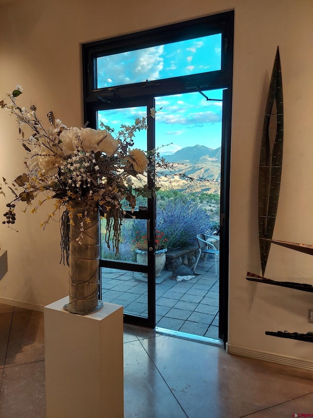 entryway with concrete flooring and a mountain view