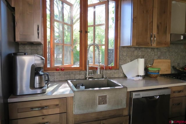 kitchen with wall chimney exhaust hood, sink, tasteful backsplash, stainless steel dishwasher, and black gas cooktop