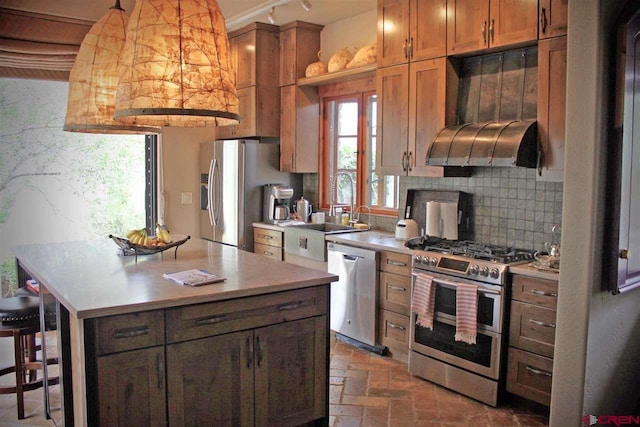 kitchen with ventilation hood, stainless steel appliances, a kitchen island, decorative backsplash, and a kitchen breakfast bar