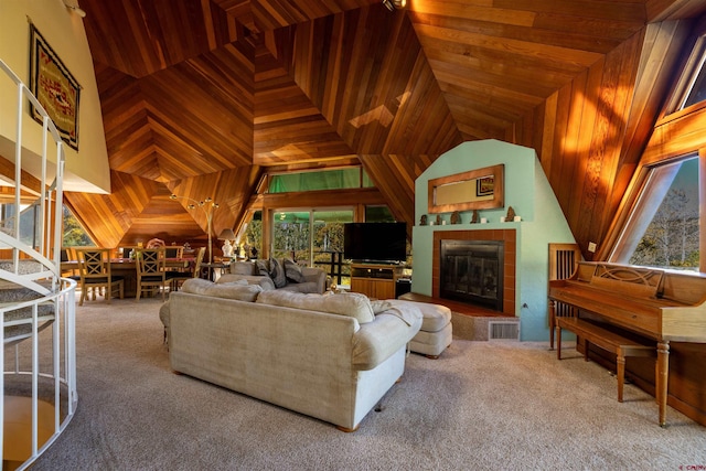 living room with lofted ceiling, a tile fireplace, wooden ceiling, and carpet floors