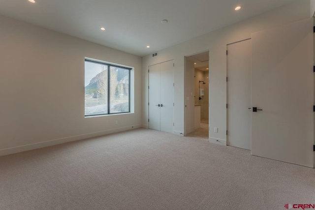 77 Coyote Ridge Rd, Crested Butte, CO 81224 - unfurnished bedroom featuring visible vents, multiple closets, baseboards, recessed lighting, and light colored carpet