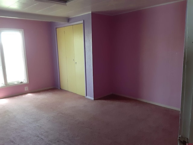 unfurnished bedroom with light carpet and a closet