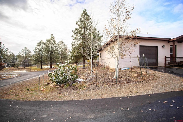 view of side of home with a garage