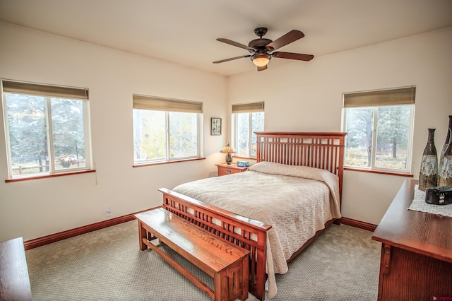 bedroom with ceiling fan, multiple windows, and carpet