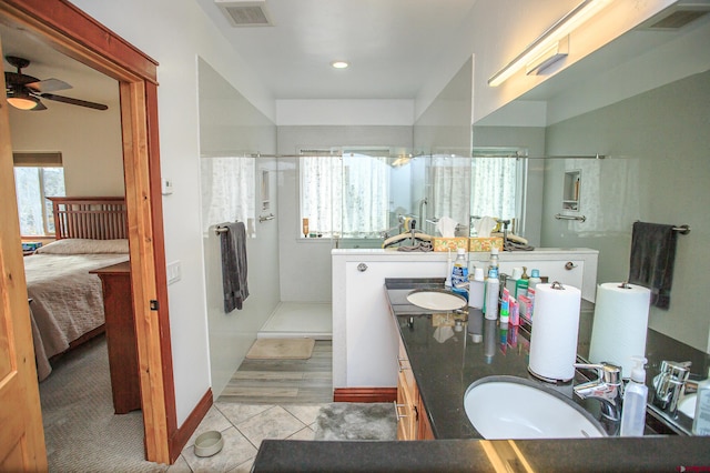 bathroom with walk in shower, vanity, a healthy amount of sunlight, and ceiling fan