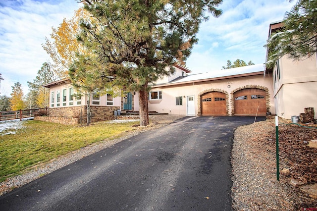 view of front of home with a garage and a front lawn