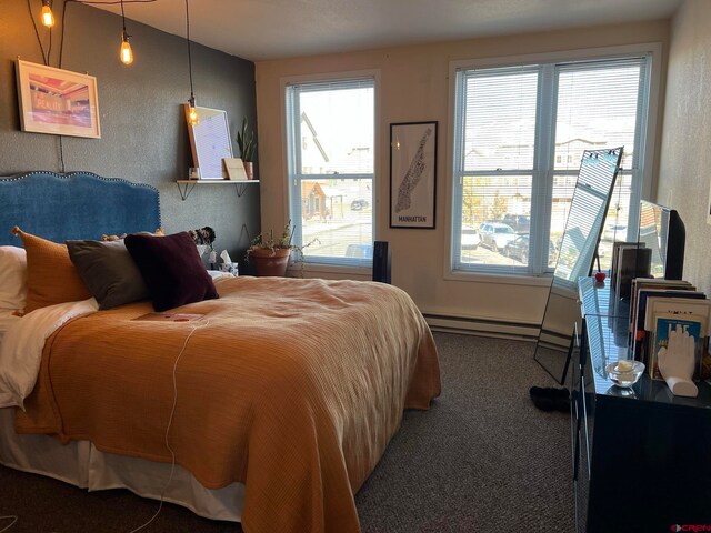 carpeted bedroom featuring a baseboard heating unit