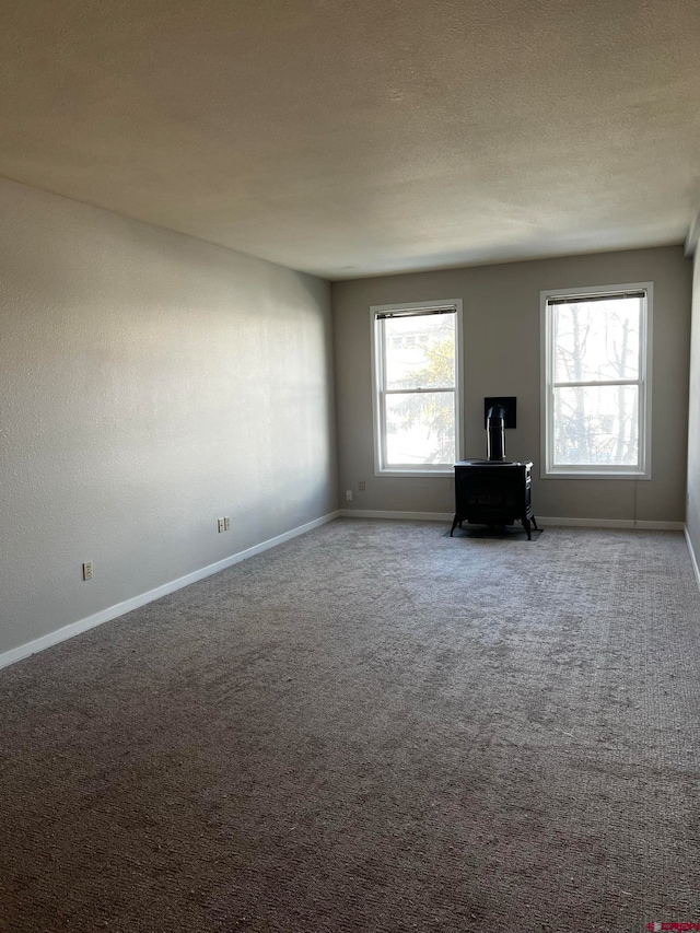 unfurnished living room featuring carpet and a textured ceiling