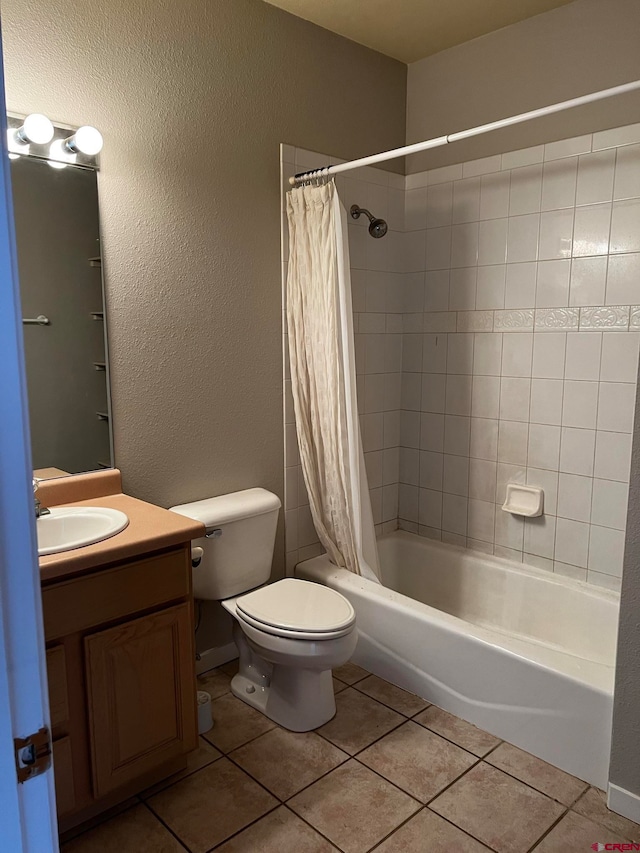 full bathroom featuring toilet, shower / bath combo, vanity, and tile patterned flooring