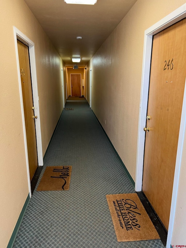 hallway with dark carpet