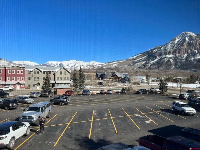 view of vehicle parking with a mountain view