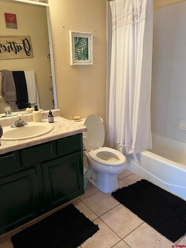 full bathroom with toilet, vanity, tile patterned floors, and shower / tub combo with curtain