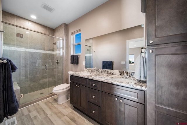449 Birch St, Bayfield, CO 81122 - full bathroom with wood finished floors, double vanity, a shower stall, and toilet