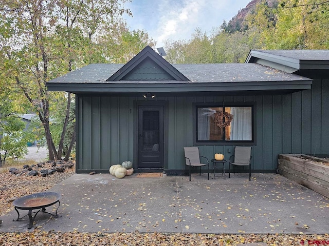 view of exterior entry with a patio area