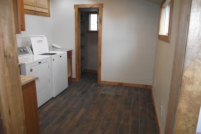 laundry room with cabinets, dark hardwood / wood-style flooring, and washer and clothes dryer