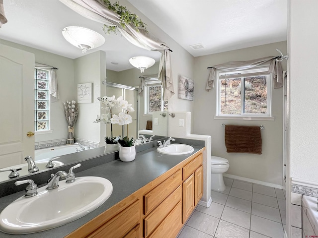 full bathroom with plus walk in shower, tile patterned flooring, vanity, and toilet