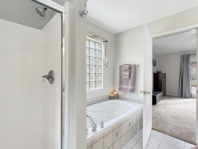 bathroom with independent shower and bath and tile patterned floors