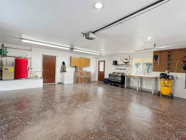 garage with electric water heater and a garage door opener