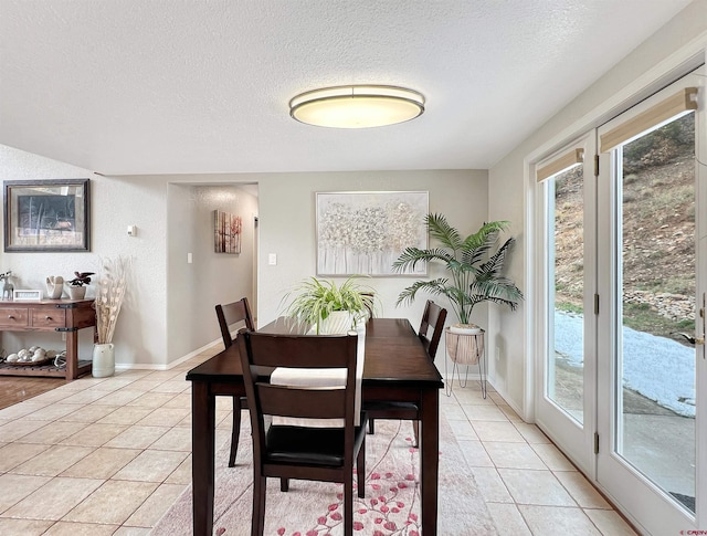 tiled dining room with a textured ceiling