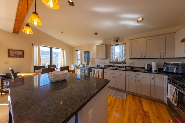 kitchen with appliances with stainless steel finishes, decorative light fixtures, light hardwood / wood-style flooring, gray cabinets, and lofted ceiling