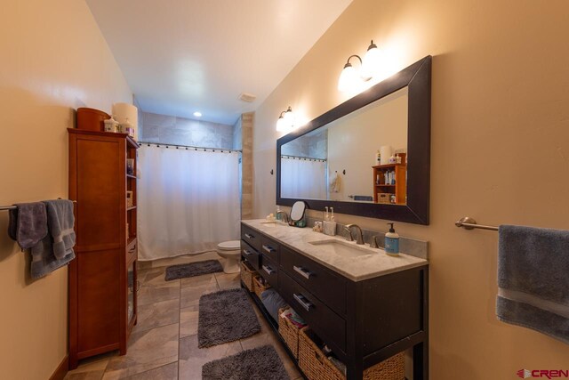 bathroom with vanity, toilet, and a shower with shower curtain