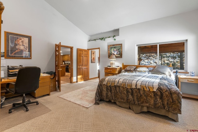 bedroom with high vaulted ceiling and light colored carpet