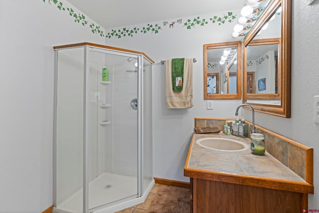 bathroom featuring tile patterned flooring, vanity, and walk in shower