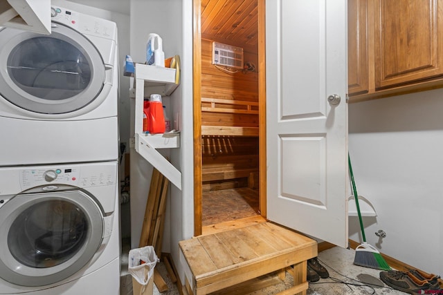 laundry area with cabinets, wooden ceiling, and stacked washer / drying machine