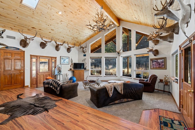 living room with hardwood / wood-style floors, wooden ceiling, high vaulted ceiling, a skylight, and beamed ceiling