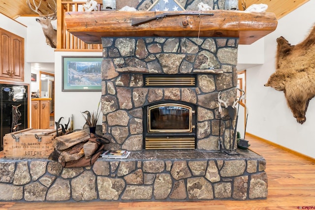 details with a fireplace, wood-type flooring, and wood ceiling