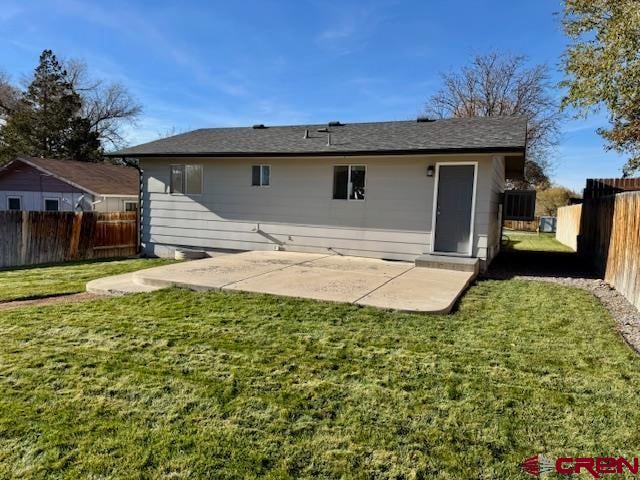 rear view of property with a yard and a patio