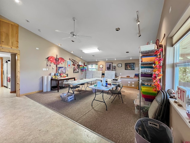 recreation room with ceiling fan, plenty of natural light, light colored carpet, and track lighting