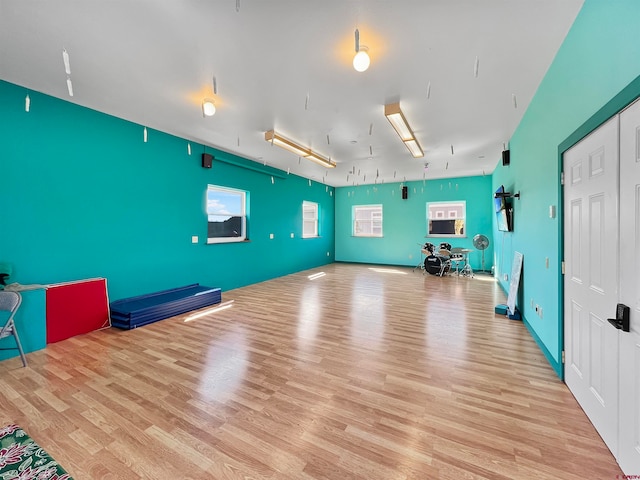 workout room with light hardwood / wood-style floors