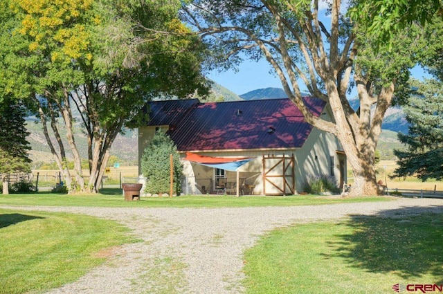 exterior space with a mountain view and a yard