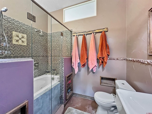 bathroom featuring toilet and combined bath / shower with glass door