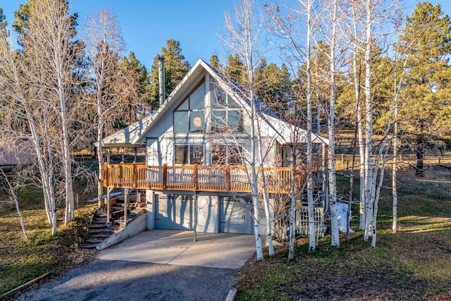 view of front facade with a garage and a deck