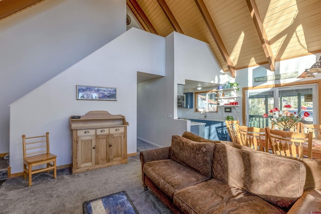 living room featuring carpet flooring, beamed ceiling, high vaulted ceiling, and wooden ceiling