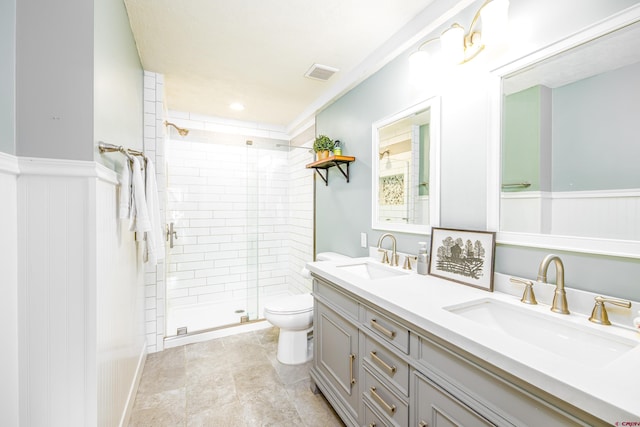 bathroom with vanity, toilet, and a shower with shower door