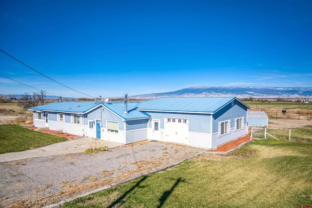 single story home with a mountain view and a front yard