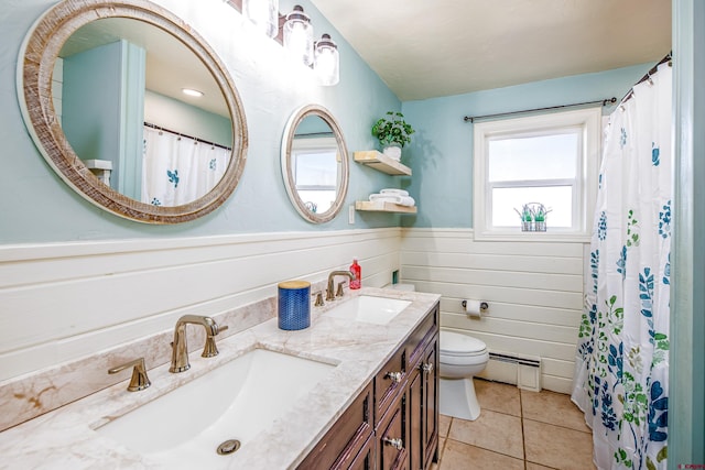 bathroom with tile patterned flooring, vanity, toilet, and baseboard heating