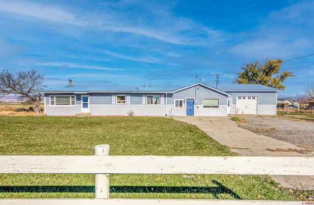 view of front facade with a front yard and a garage