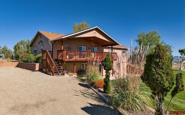 back of property featuring a wooden deck