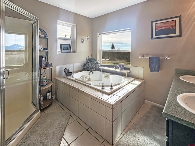 bathroom with shower with separate bathtub, vanity, and tile patterned floors