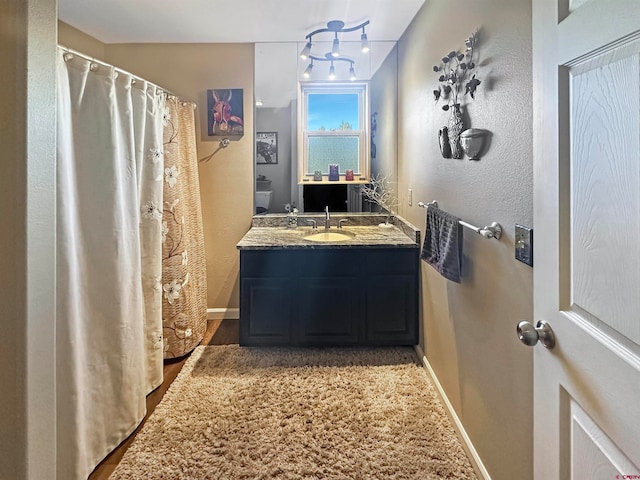 bathroom featuring vanity and hardwood / wood-style flooring