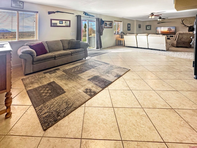 tiled living room with ceiling fan